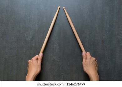 Hand Holding Drum Stick On Black Table Background, Music Practice Concept