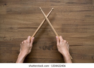 Hand Holding Drum Stick On Black Table Background, Music Practice Concept 