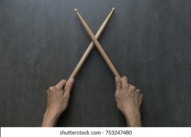 Hand Holding Drum Stick On Black Table Background, Music Practice Concept