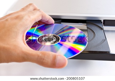hand holding dvd insert to dvd player