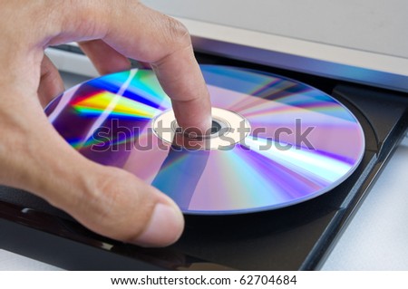 hand holding dvd insert to dvd player