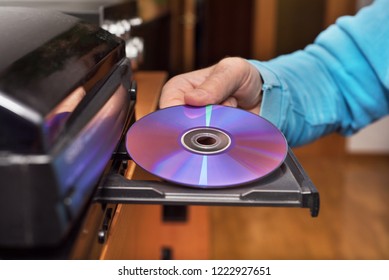 Hand Holding DVD Inserting To Video Player