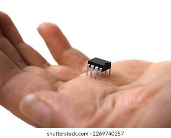 Hand holding an eight-pin chip. Isolated integrated circuit.      