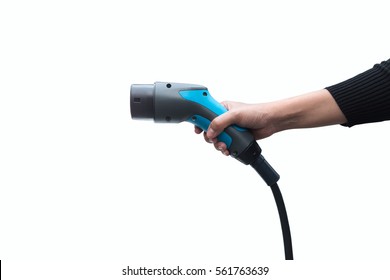 Hand holding Electric car charger on white background. Air pollution and reduce greenhouse gas emissions concept.
