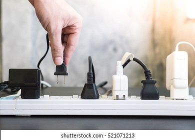 Hand holding electric plug, Multiple socket with connected plugs. - Shutterstock ID 521071213