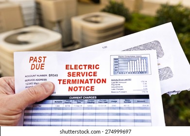 Hand Holding Electric Service Termination Notice In Front Of Air Conditioning Units