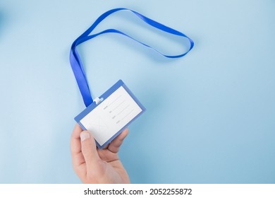 Hand Holding Employee Id Tag