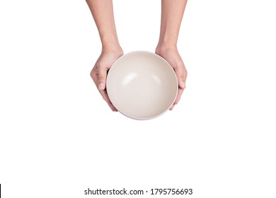 Hand holding empty ceramic bowl isolated on white background. Top view