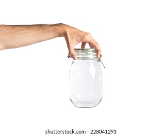 Hand Holding Empty Glass Jar Over Background 