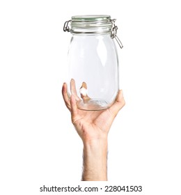 Hand Holding Empty Glass Jar Over Background 