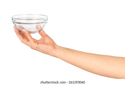Hand holding an empty glass salad bowl isolated on white background
