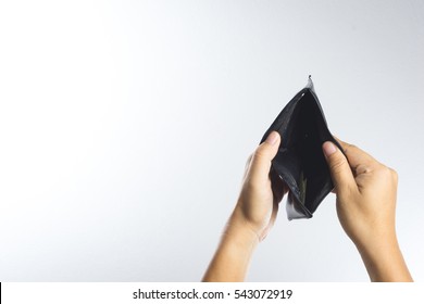 Hand holding empty old wallet on white background