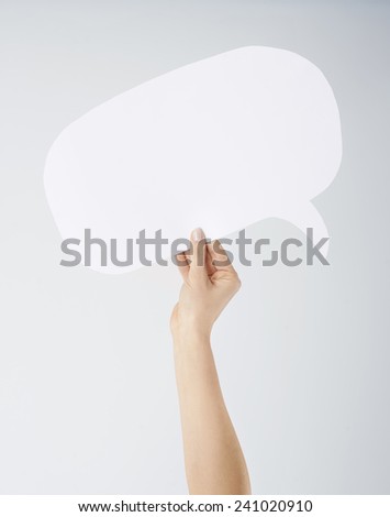Hand holding empty speech bubble 