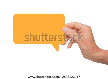 Hand holding an empty speech bubble, symbolizing communication and feedback. Concept of online dialogue, conversation, and business marketing. Orange chat box. Isolated on white background.
