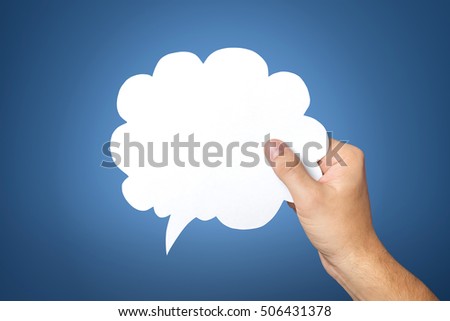 Hand holding an empty speech bubble on blue background