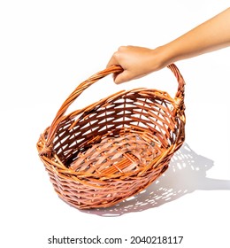 Hand Holding Empty Wicker Basket. Isolated On White.