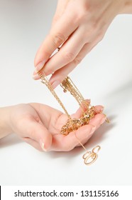 Hand Holding Expensive Gold Jewelry