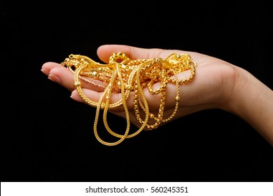 Hand Holding Expensive Gold Jewelry Necklace And Bracelet
