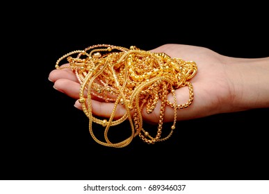 Hand Holding Expensive Gold Jewelry Necklace And Bracelet