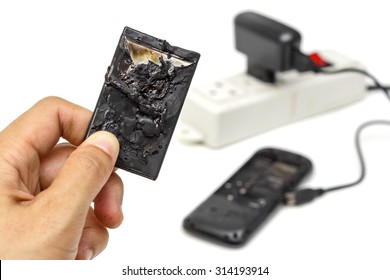 hand holding an exploded mobile phone battery