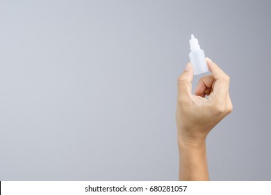 Hand Holding Eye Or Ear Drop Bottle On White Background