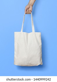 Hand Holding Fabric Canvas Tote Bag or Goodie Bag Isolated on White Colour Background - Shutterstock ID 1440999242