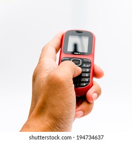 A Hand Holding A Feature Phone