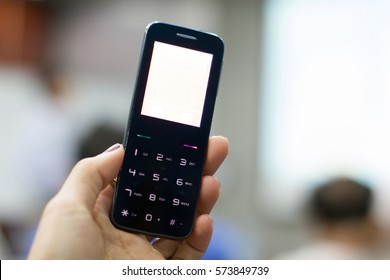 A Hand Holding A Feature Phone