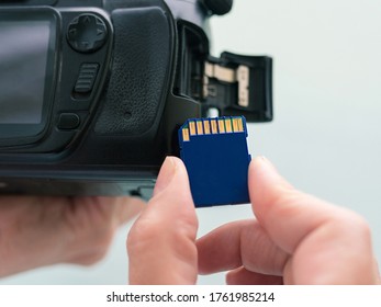 Hand Holding Flash Card And Digital Camera. Technology, Photographer, Shooting, Professional Concept