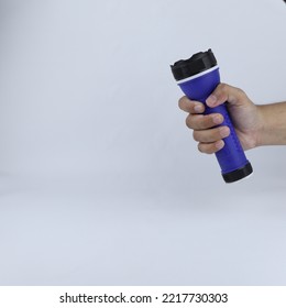 Hand Holding A Flashlight Isolated On A White Background