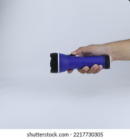 Hand Holding A Flashlight Isolated On A White Background