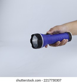 Hand Holding A Flashlight Isolated On A White Background