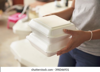 Hand holding foam boxes rice.