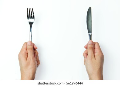 Hand Holding Fork And Knife On White Background