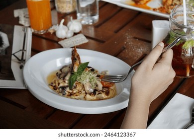 Hand holding fork while having lunch