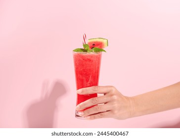 hand holding fresh watermelon juice or smoothie in glasses with watermelon pieces on studio background. Refreshing summer drink - Powered by Shutterstock