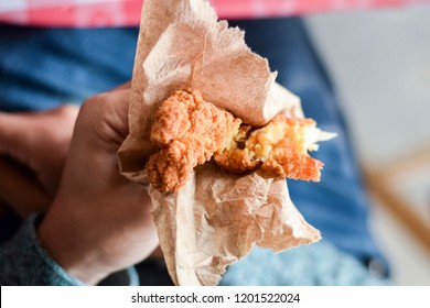 Hand Holding Freshly Fried Chicken Finger, About To Eat