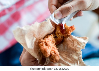 Hand Holding Freshly Fried Chicken Finger, About To Eat