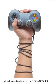 Hand Holding Game Controller And Tied Up With Cables Isolated On The White Background