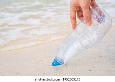 Hand Holding And Garbage Collection Empty Water Bottle On The Beach.clean The Sea Beach And Ocean Save Earth And Save The World Campaign Concept.