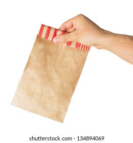 Hand Holding Or Giving A Brown Paper Bag