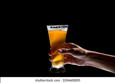 Hand Holding Glass Of Craft Beer On Black Background