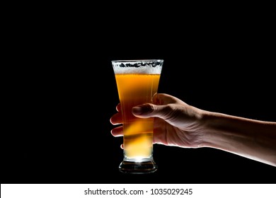 Hand Holding Glass Of Craft Beer On Black Background