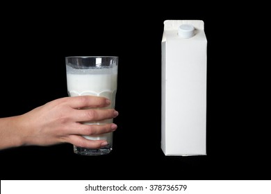 Hand Holding Glass Of Milk Isolated On Black Background