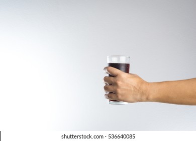 Hand Holding A Glass Of Soda Water On White Background