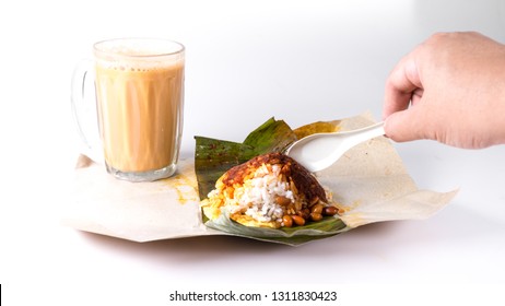 Hand Holding Glass Or Spoon Eating Malaysian Traditional Local Dish Named Nasi Lemak And Favorite Local Beverage Named Teh Tarik. Isolated On White Background. Copy Space.