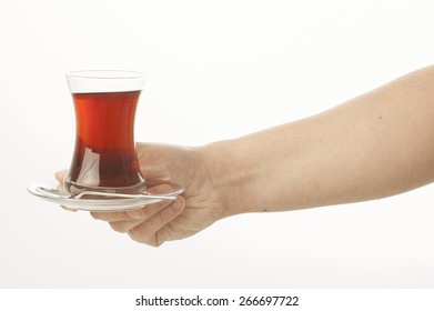 Hand Holding A Glass Of Turkish Tea On White