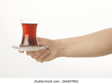 Hand Holding A Glass Of Turkish Tea On White