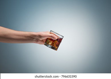 Hand Holding A Glass Of Whiskey