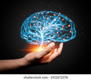 Hand holding glowing brain on dark background. AI network of brain on business analysis, innovative and business growth development.
